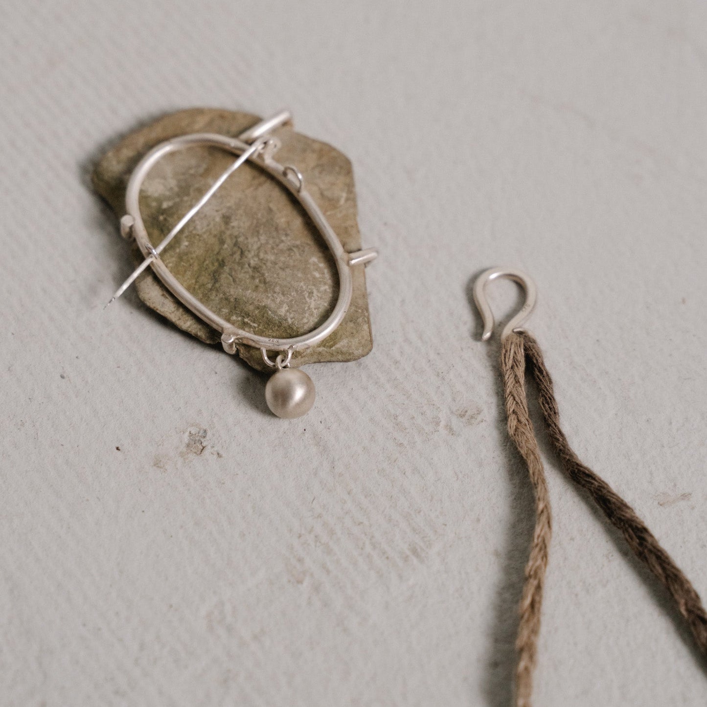 river stone brooch two